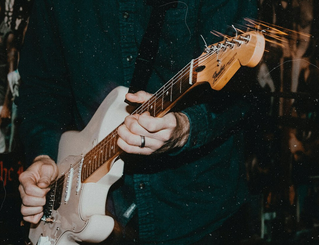 Uruguayan musician playing electric guitar on stage